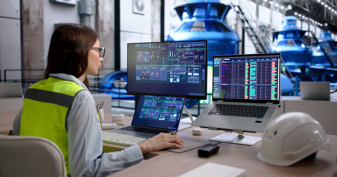 Young Woman Monitoring Hydroelectric Power Plant System