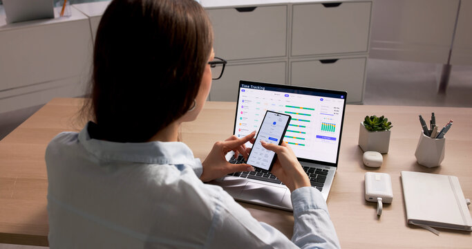 Young Female Project Manager Uses Smartphone App
