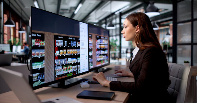 Young Retail Manager Uses Computer Software