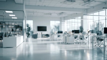 Obraz premium Modern bright open-plan office interior with desks and workstations bathed in natural light