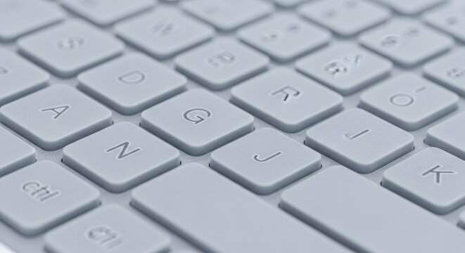 Close-up of a modern computer keyboard with white keys and letters.