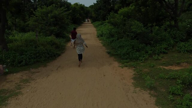 Aerial view of devotees walking on the sacred Govardhan Parvat Parikrama Marg surrounded by lush greenery, Mathura.
