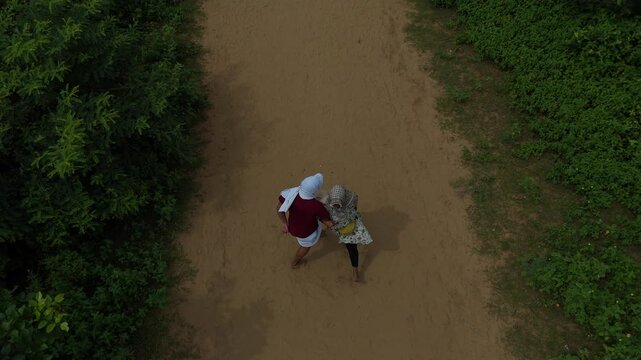 Aerial view of devotees walking on the sacred Govardhan Parvat Parikrama Marg surrounded by lush greenery, Mathura.