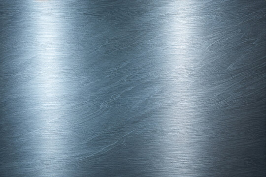 Realistic brushed metal texture with polished stainless steel finish. Industrial silver metallic background featuring fine hairline scratches, smooth reflections, and premium steel surface details.