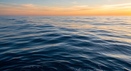 Fototapeta premium Serene ocean waves at sunset with warm sky and gentle ripples on the water surface
