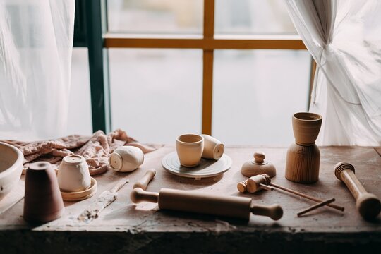 Pottery studio scene with ceramic cups and crafting tools