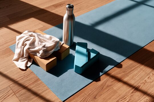Minimal fitness setup with yoga blocks and stainless bottle