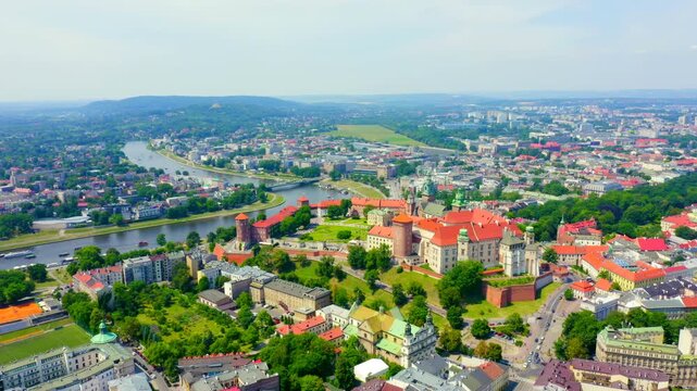 Krakow, Poland. Wawel Castle, red-roofed Renaissance palace crowning a limestone hill above the Vistula River, aerial panoramic view under clear summer sky. Drone footage, Point of interest