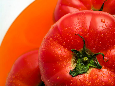 Macro Fresh Tomato On Orange Plate Close Up