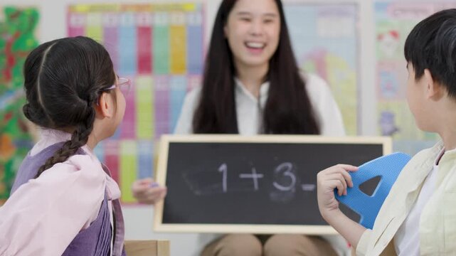 Thai Elementary Students Solve Math Problems with Teacher in Classroom