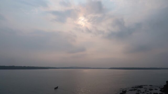 Timelapse of South Indian river during sunset with clouds and boat moving