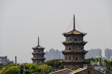 Fototapeta premium The iconic twin stone pagodas inside Quanzhou Kaiyuan Temple. Classic ancient Buddhist architecture with profound historical heritage and traditional southern Chinese architectural charm.