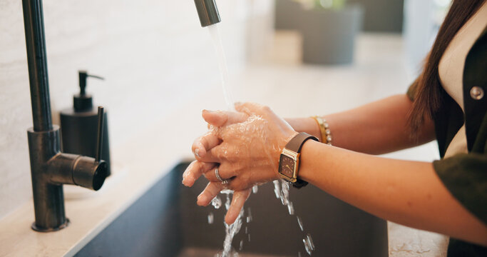 Woman, hands and washing with water in sink for hygiene, disinfection or cleaning in home. Female person, splash and rinsing with faucet, tap or safety in basin for dirt, bacteria or germ removal