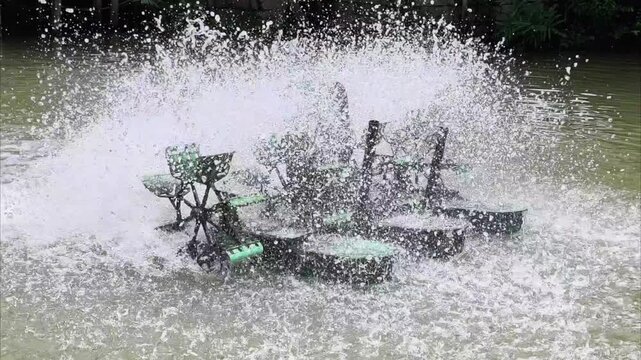 Water aerator splashing intensely in a pond for oxygen circulation and water treatment.