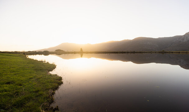 placid pond at sunset, overlooking Klein Mountains, Stanford, South Africa