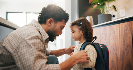 Education, dad and child with backpack in kitchen, family and getting ready for first day of school. Man, home and help girl with bag for daycare, morning routine and preparing toddler to leave © peopleimages.com