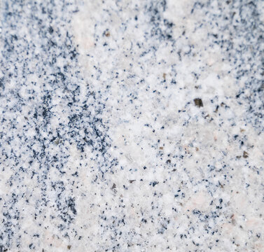 A collection of natural material samples is displayed in an organized composition featuring sintered stone, granite, and transparent glass textures. Each surface reveals unique veins, grains, reflecti