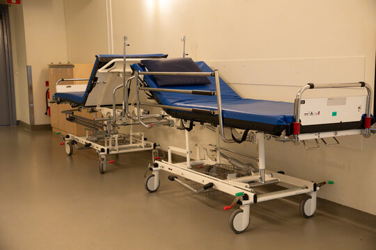 Medical stretchers in empty hospital corridor