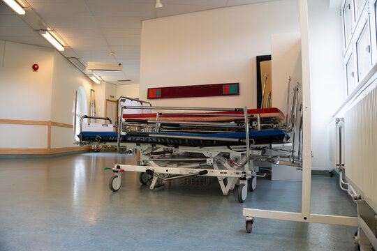 Medical stretchers in empty hospital corridor