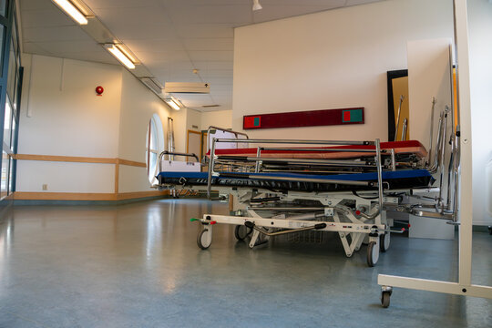 Medical stretchers in empty hospital corridor