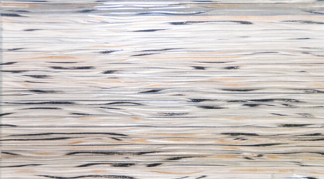 A collection of natural material samples is displayed in an organized composition featuring sintered stone, granite, and transparent glass textures. Each surface reveals unique veins, grains, reflecti