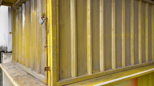 Close up of closed storefront with yellow galvalume sliding wall