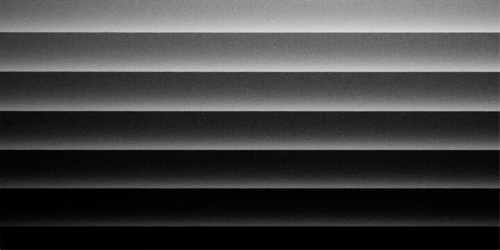 Abstract, black and white photograph captures the play of light and shadow, resulting in a minimalist yet striking composition, with horizontal lines creating visual rhythm.
