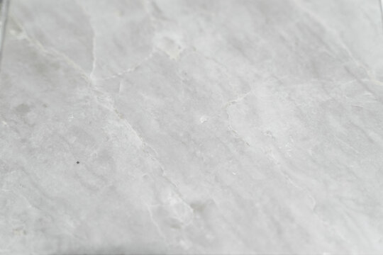 A collection of natural material samples is displayed in an organized composition featuring sintered stone, granite, and transparent glass textures. Each surface reveals unique veins, grains, reflecti