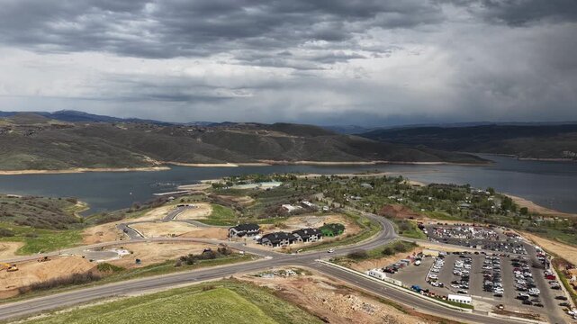 Aerial of Jordanelle Reservoir homes and parking lot in Heber Valley Utah in spring