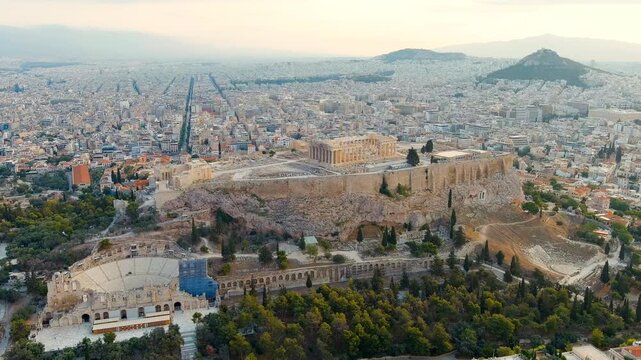 Athens, Greece. The Acropolis and Parthenon, honey-colored marble temple crowning a rocky plateau, aerial panoramic view in soft morning summer light. Drone footage, Point of interest