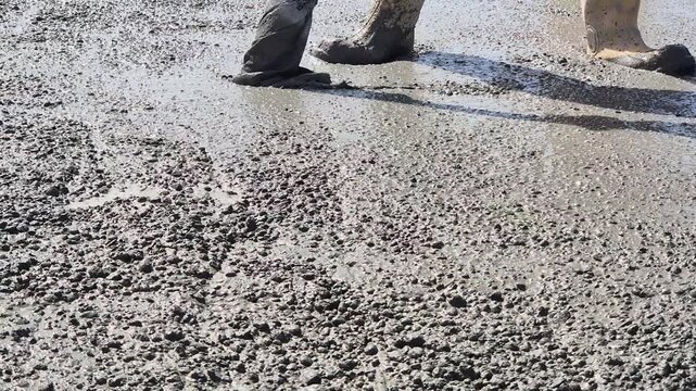 Vibrating freshly poured concrete slab - Low Angle Slow Motion