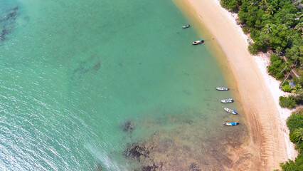 Aerial View of Longtail Boats Anchored Along a Tropical Beach in Krabi © blueringmedia