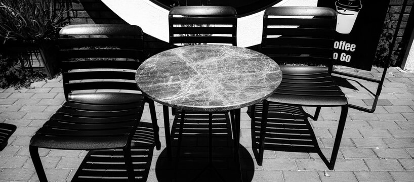 Round Outdoor Table with Chairs in Monochrome