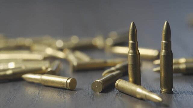 Many bullets on a wooden table. Concept of military, weapons and ammunition.