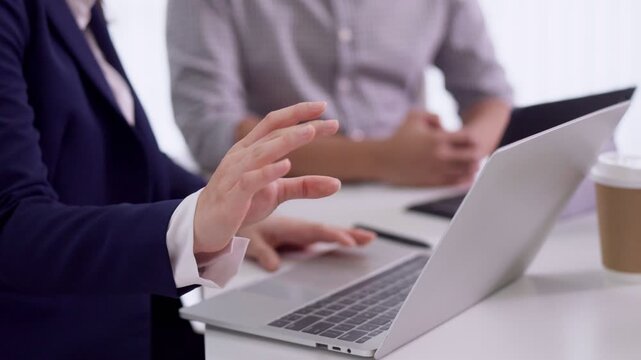 business women colleagues hands collaborate with laptop computer notebook meeting brainstorm teamwork planning discuss professional corporate office workspace