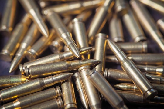 Many metalic bullets on background.