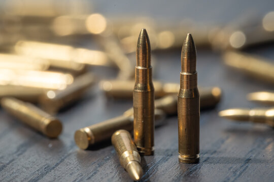 Many bullets on a wooden table. Concept of military, weapons and ammunition.