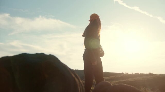 Stylish man with fantasy elf ears posing confidently in a desert landscape. Cinematic fashion aesthetic, dramatic light, and surreal atmosphere create a unique fantasy-inspired scene.