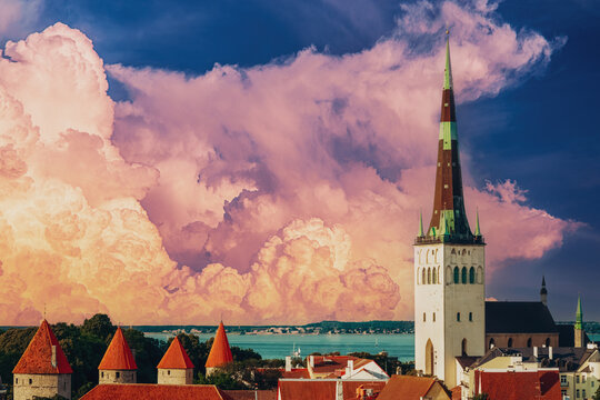 St. Olaf's Church spire and defensive walls under dramatic clouds