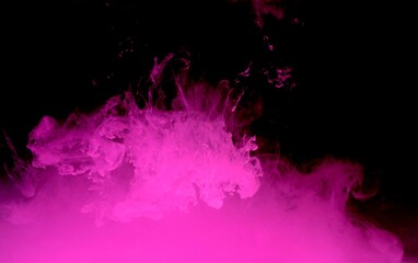 Obraz premium Pink colorful fluorescent smoke on black background,Art abstract smoke texture,Colored liquid dye,Splash paint,Abstract color,Abstract Textures