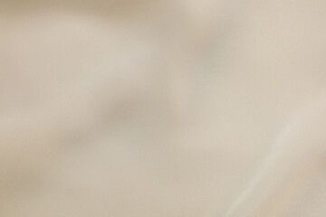 Obraz premium Elegant beige silk fabric texture background with soft folds and smooth luxury textile waves