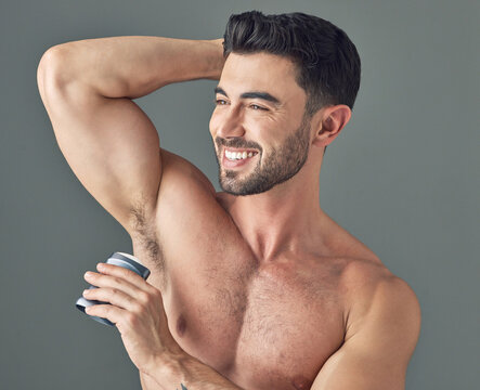 Man, deodorant and clean armpit with hygiene, routine and control sweat with beauty product in studio. Antiperspirant, underarm smell or scent prevention or skincare for cosmetics on gray background