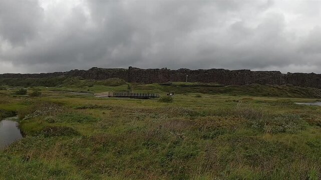 Thingvellir National Park with wooden boardwalk and distant church, Iceland