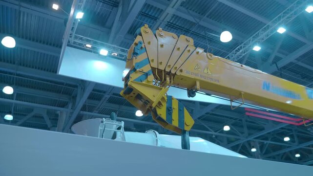 The powerful telescopic boom and hook of the new truck crane are presented at the exhibition. Shot in motion