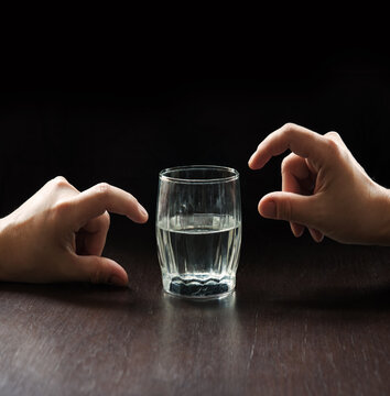 An optimist and a pessimist's opinion about a glass of water