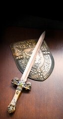 Fototapeta premium Iron shield and sword on the table