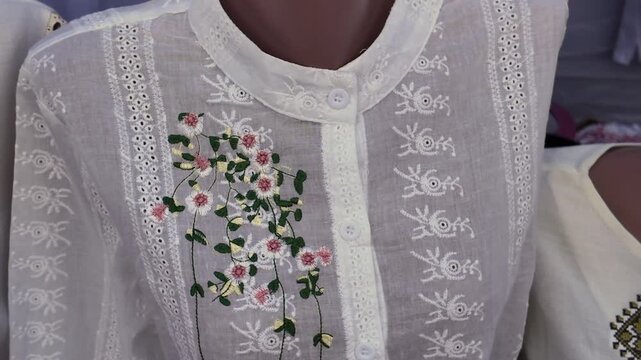 White thin cotton women's blouse embroidered with floral pattern 
