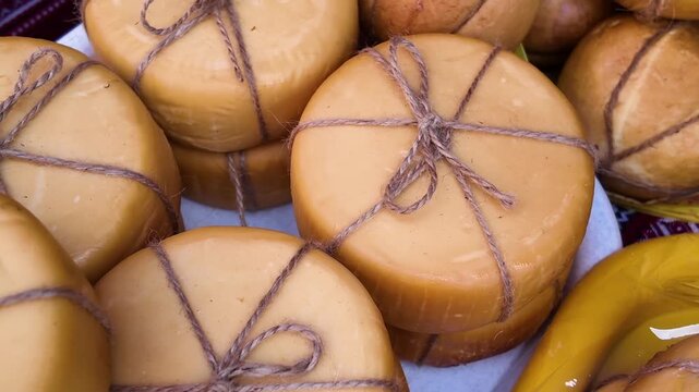 Showcase with farm cheeses of different varieties at the fair, background