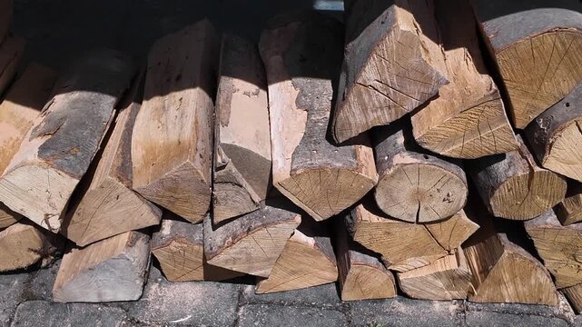Neatly stacked firewood from beech wood harvested for household use, kindling a barbecue or fireplace, background