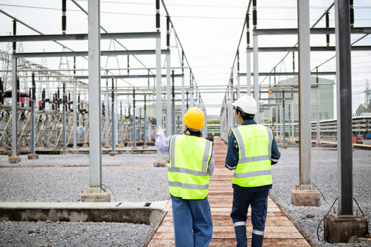 Engineers walk through an electrical substation during power grid inspection, supporting safety planning, utility maintenance, and high voltage infrastructure reliability.